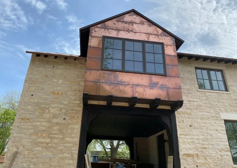 Copper metal panel facade on a stone building for Skylight Installation in Five Forks